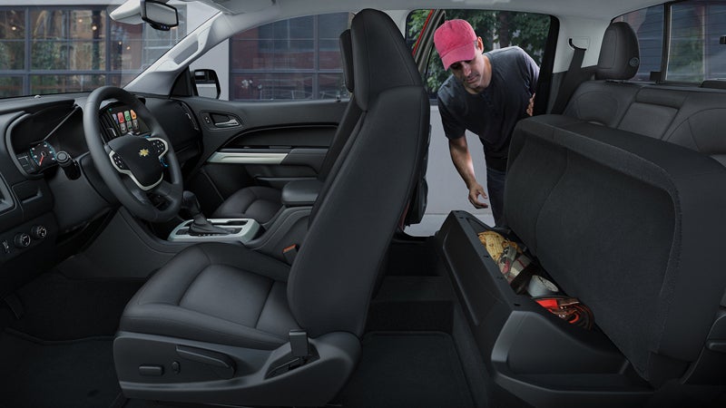 The cabin of a 2018 Chevy Colorado with a man in a baseball cap