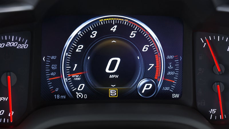 Dashboard of a Chevy Corvette Z06, featuring a speedometer and various gauges for performance monitoring.