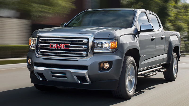 A 2018 GMC Canyon driving along a scenic road